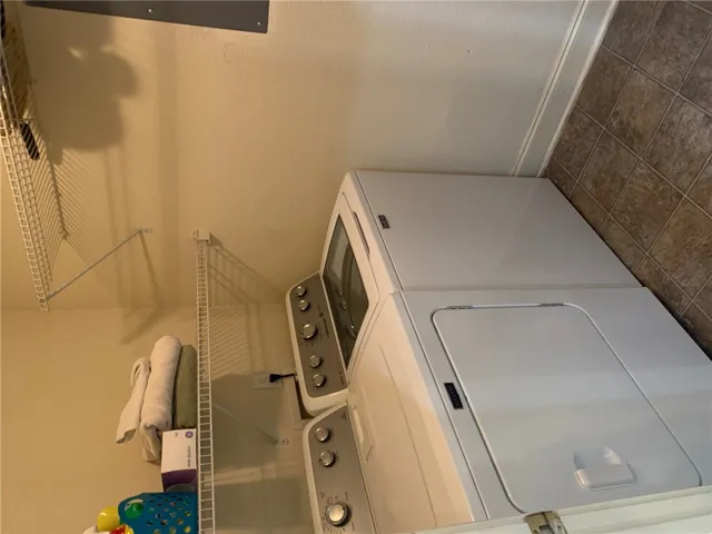 This dedicated laundry space features efficient appliances and convenient storage solutions.