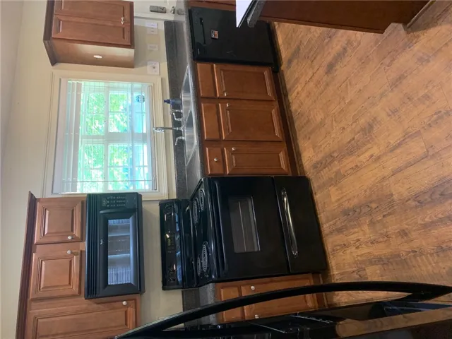 This spacious kitchen offers ample cabinet storage, generous counter space, and a delightful window view.