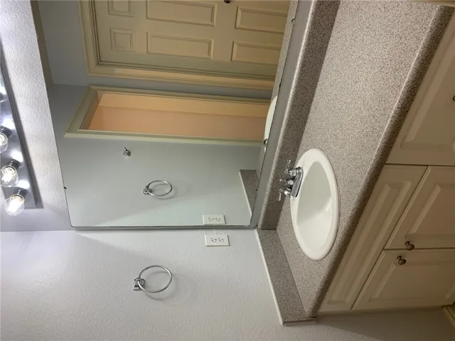 This bathroom features a sleek vanity, offering both style and essential storage.