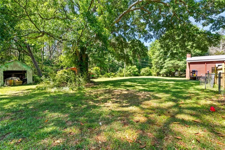 Expansive green space offers potential for creative outdoor living.