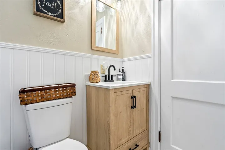 This bathroom features a contemporary vanity with a sleek faucet and a practical toilet, enhancing its modern appeal.