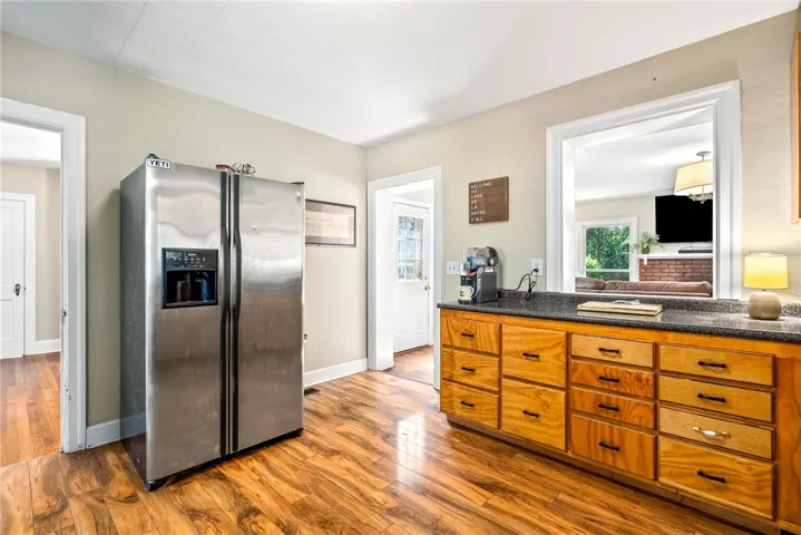 This spacious kitchen offers ample storage and a pass-through window to the living area.