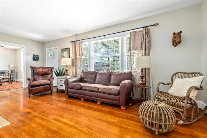 Bright and airy living room features large windows.