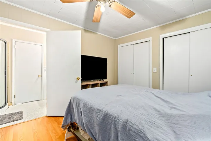 This cozy bedroom features dual closets for ample storage.