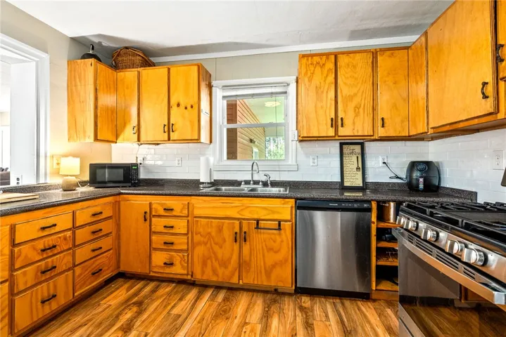 This spacious kitchen offers ample storage, essential appliances, and an inviting ambiance for daily living.