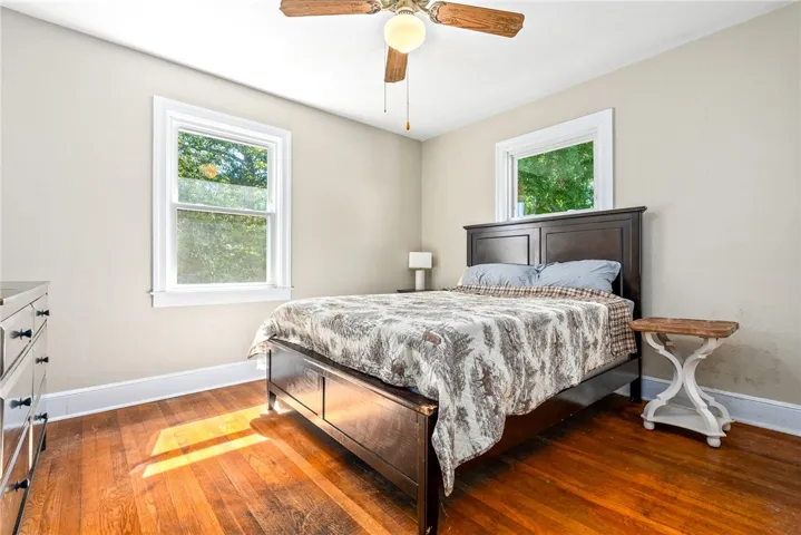 Bright and airy bedroom features large windows inviting abundant natural light.