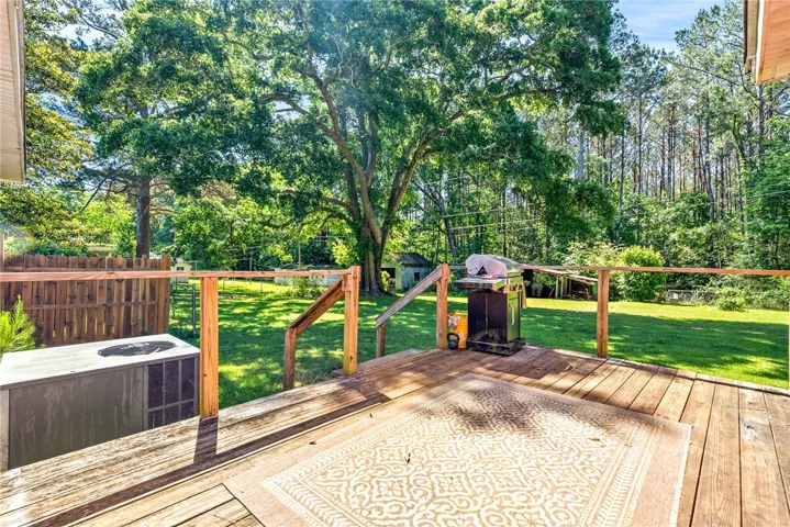 This spacious deck offers a tranquil retreat with ample outdoor living space.