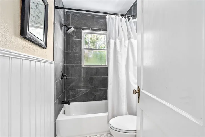 Refreshed bath with contemporary fixtures and classic wainscoting.
