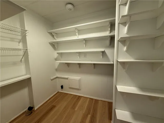 This spacious closet offers ample shelving and versatile storage options for any wardrobe.