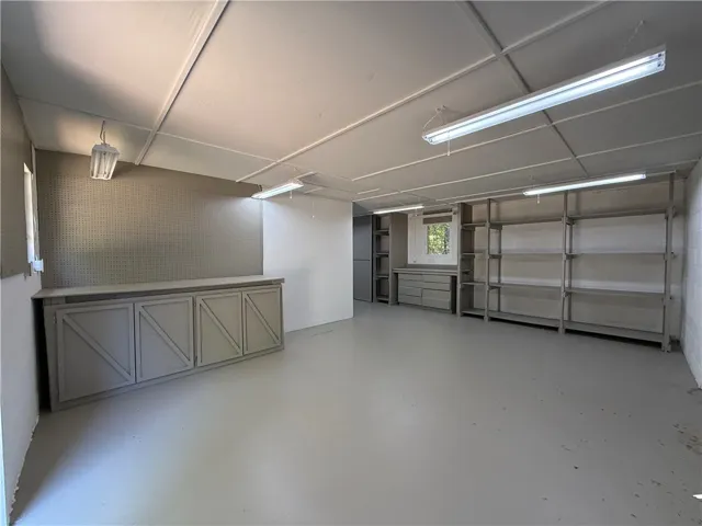 This spacious garage offers abundant storage solutions and versatile utility space.