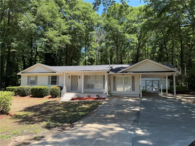 This charming residence offers comfortable living in a serene, treelined setting.