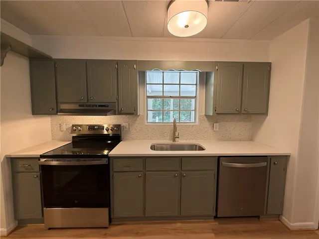 This bright kitchen features sleek appliances and ample counter space.