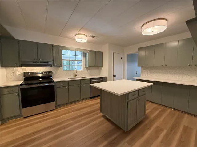 This spacious kitchen offers a blend of style and functionality, perfect for culinary adventures.