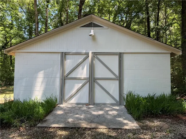 This versatile outbuilding offers practical storage solutions with a clean and classic aesthetic.