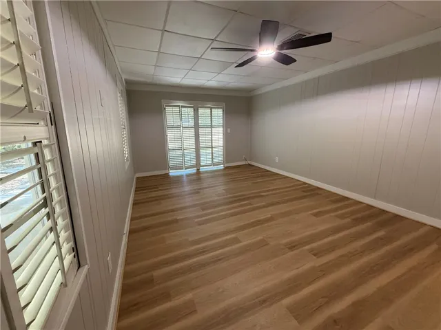 This bright room features durable flooring and convenient outdoor access, ideal for various uses.