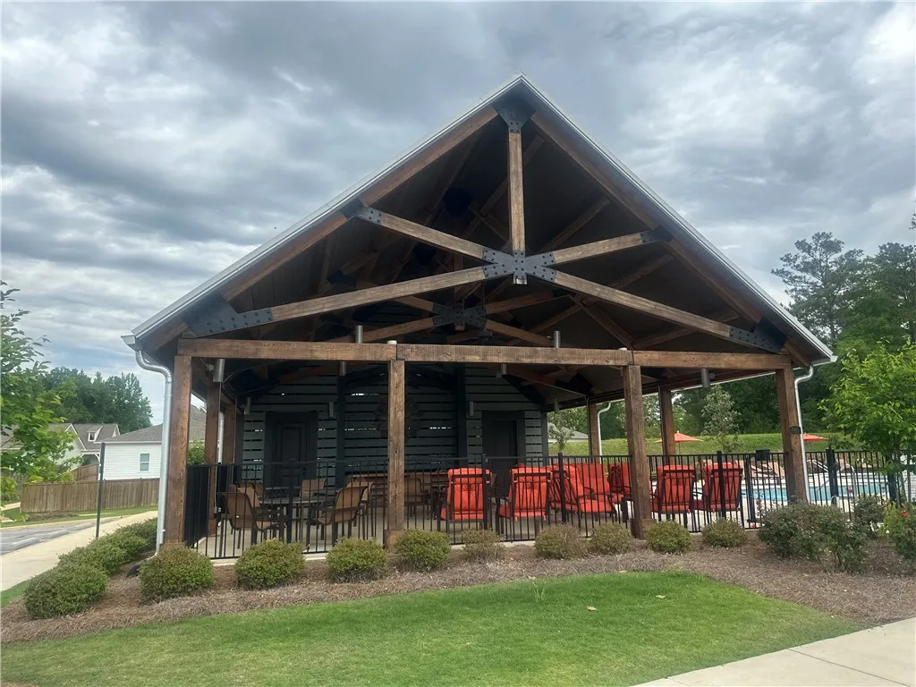 This spacious outdoor pavilion offers an inviting retreat for relaxation and entertainment.