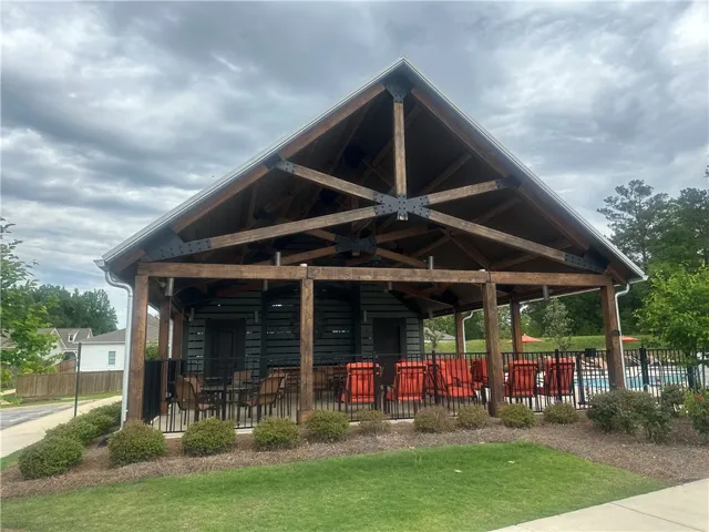 This spacious outdoor pavilion offers an inviting retreat for relaxation and entertainment.