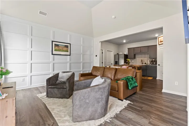 This inviting living area features a spacious open floorplan connecting seamlessly to the kitchen. The accent wall adds that special touch to this great room.