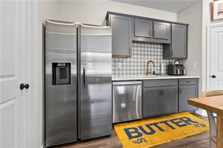This modern kitchen features sleek appliances and elegant cabinetry with upscale backsplash.