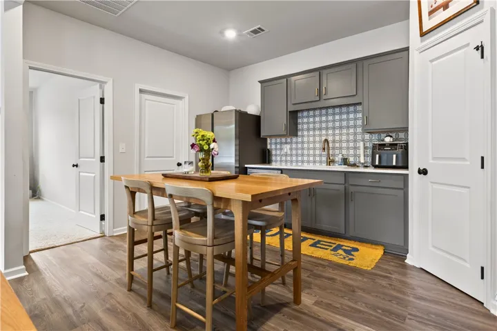 This cozy kitchen features sleek cabinetry and stylish flooring, creating an inviting space for daily living. Walk-in pantry creates extra storage space.