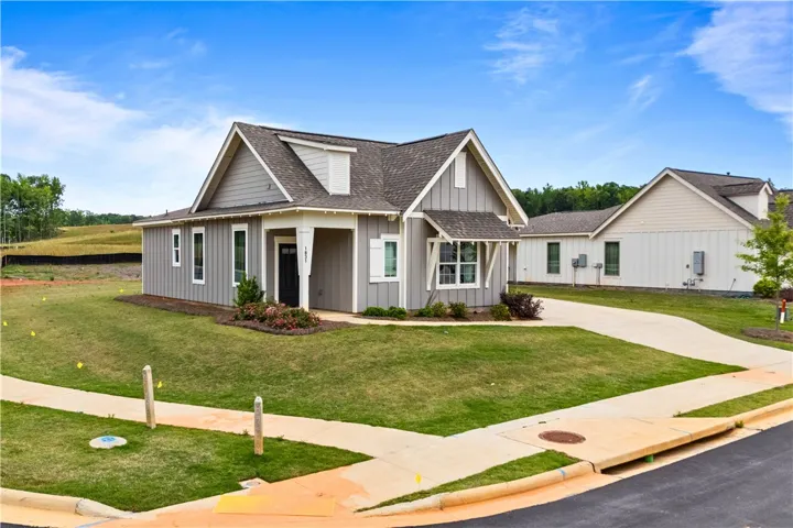 This charming home offers modern comfort and classic appeal with a welcoming exterior and thoughtful details and on a corner lot.
