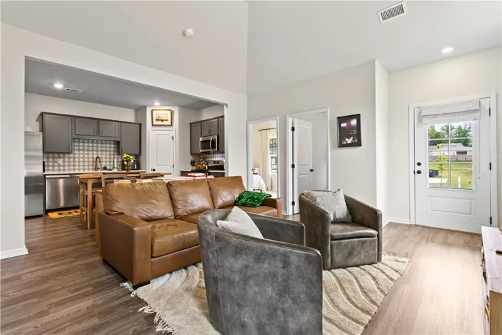 This bright living area features an open layout, connecting seamlessly to the kitchen.
