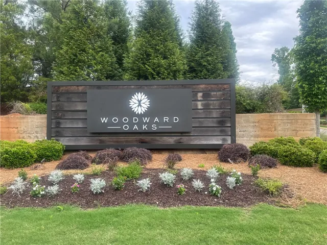 The welcoming entrance sign marks this community, surrounded by lush greenery and well-maintained landscaping.