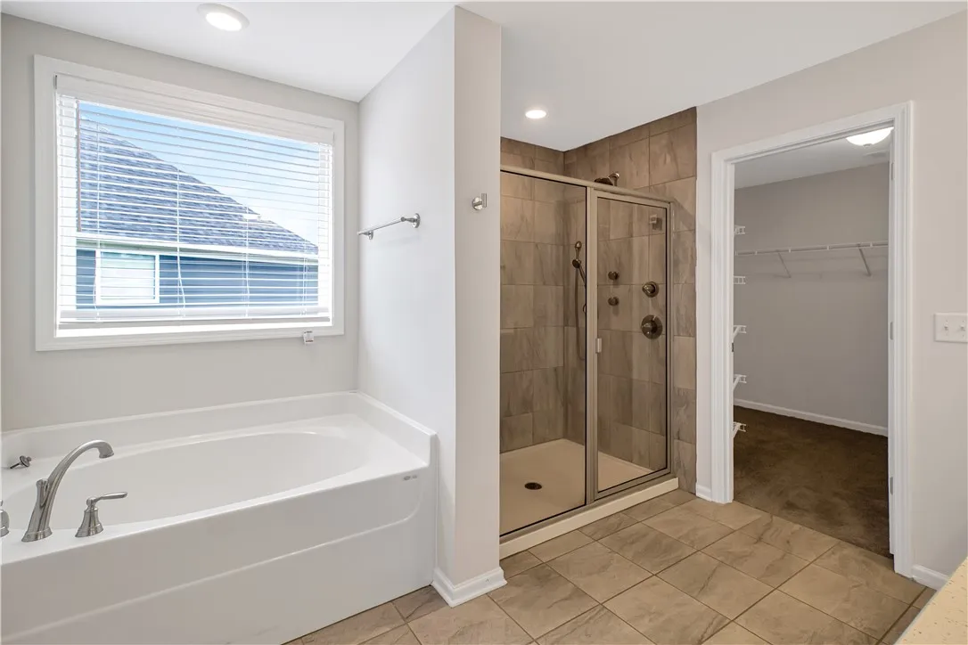 Relax in the deep soaking tub or rejuvenate in the tiled walk-in shower.
