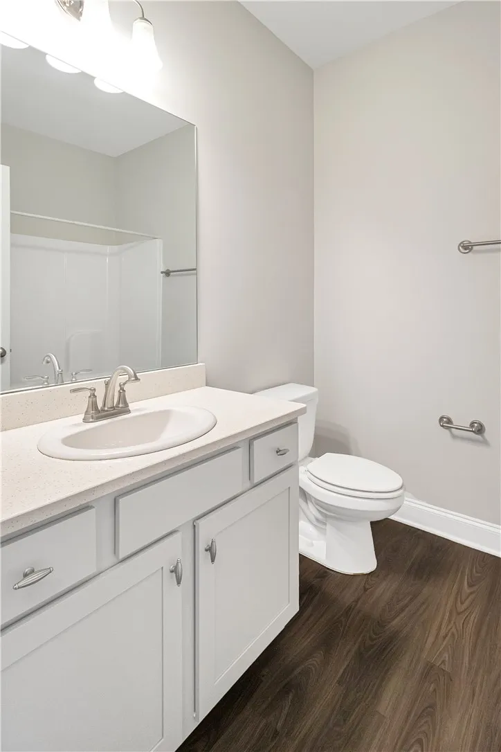 A well-appointed First Floor bathroom features a sleek vanity, mirror, and modern fixtures.