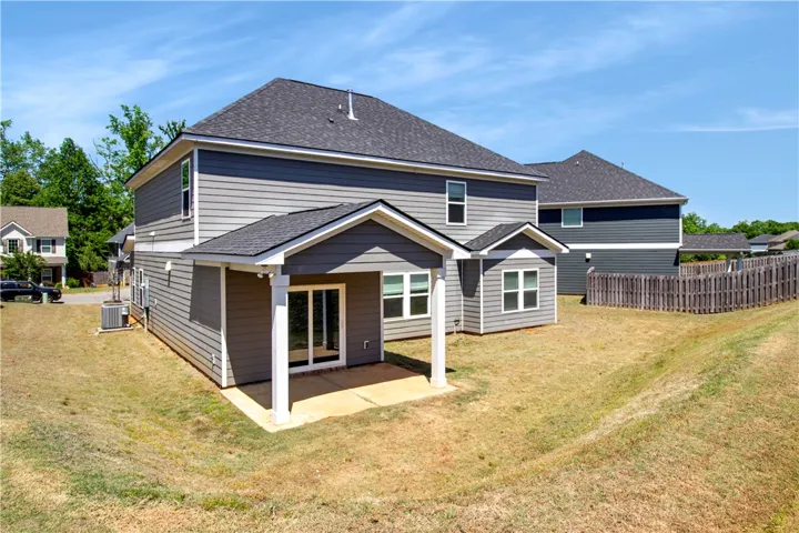 This newly constructed residence showcases a covered patio perfect for outdoor living and entertaining.