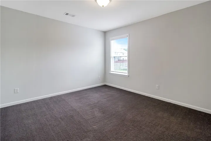 An airy bedroom with a naturally illuminated window offers comfortable living.