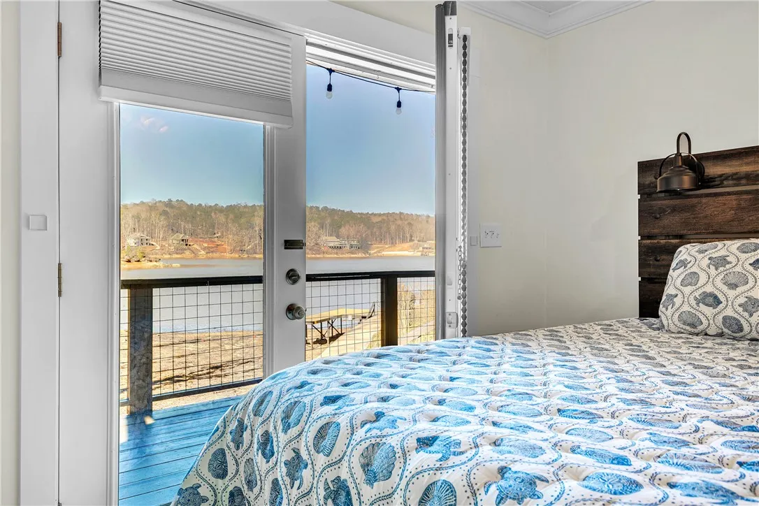 This inviting bedroom offers serene lake views, creating a peaceful and picturesque retreat.