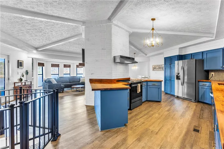 This inviting space combines a functional kitchen with a cozy living area, ideal for relaxed gatherings.
