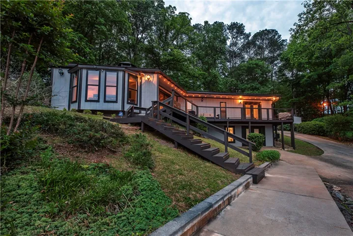 This secluded hillside home boasts an expansive deck, perfect for peaceful outdoor living.