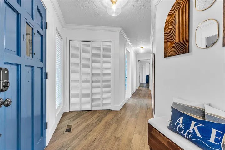 This entry hall features durable flooring and functional storage leading to a bright interior.