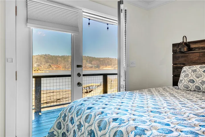 This inviting bedroom offers serene lake views, creating a peaceful and picturesque retreat.