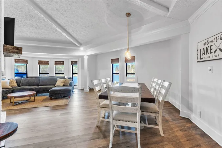 An inviting open-concept space blends living and dining areas, with a tranquil water view.