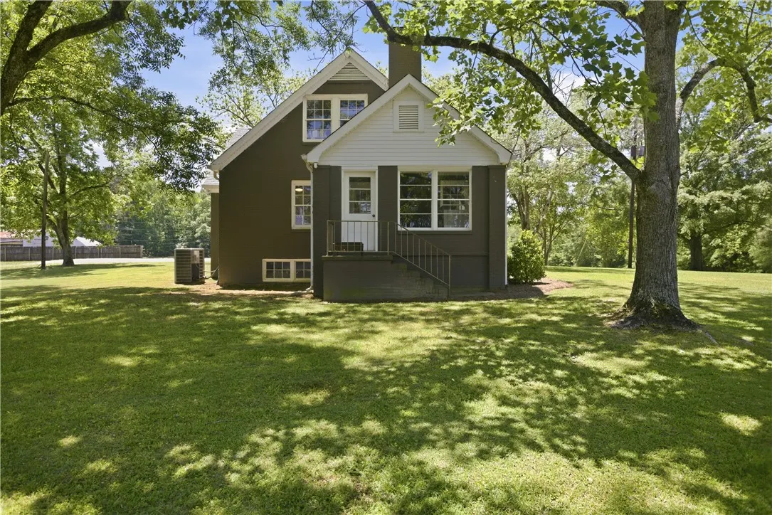 This charming home offers a lush, expansive yard perfect for outdoor enjoyment and relaxation.