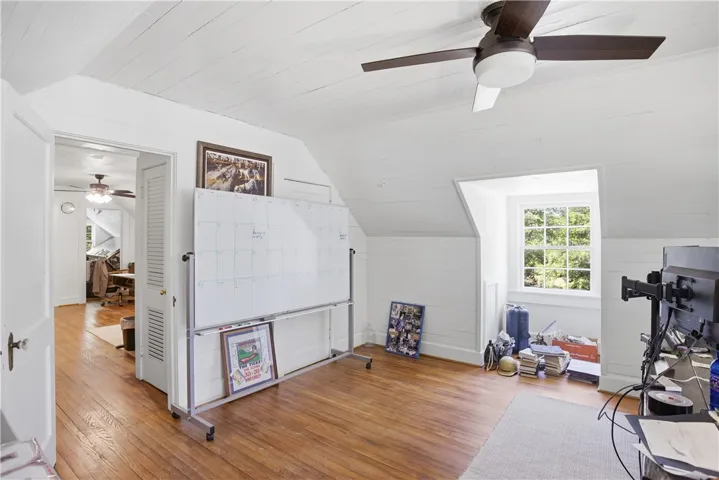 This bright office space features beautiful wood floors and a unique window, perfect for productivity.