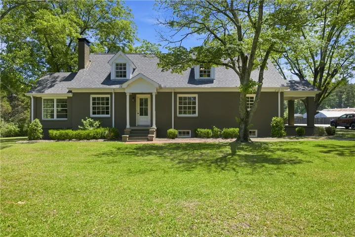 This charming home offers classic appeal with a welcoming front porch, perfect for enjoying peaceful afternoons.