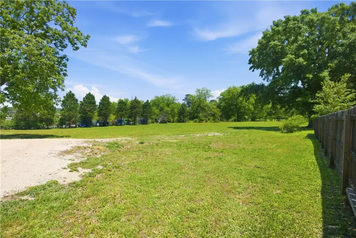 A spacious, verdant lot awaits your vision under an expansive sky.