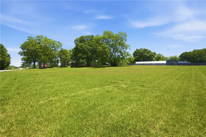 Expansive green acreage offers serene views and endless possibilities.
