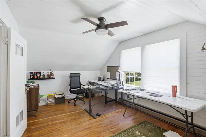 An inviting office with hardwood floors and ample natural light, creating a productive atmosphere.