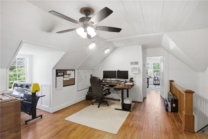 This versatile space features gleaming hardwood floors and abundant natural light, perfect for a home office or creative studio.