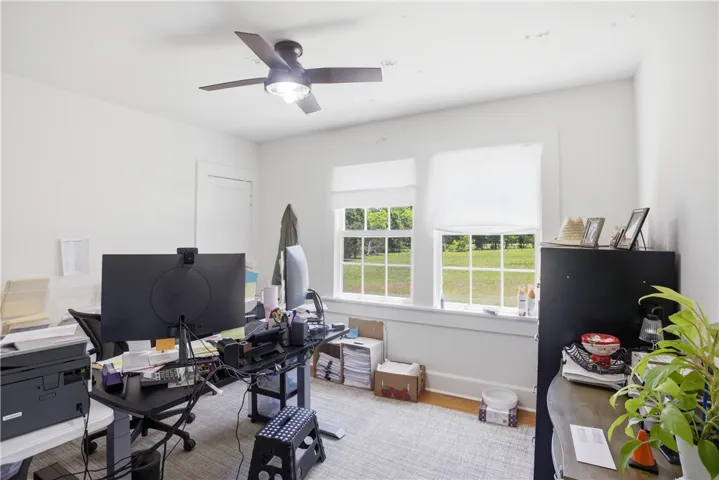 This versatile room offers ample natural light, ideal for a productive home office or creative studio.
