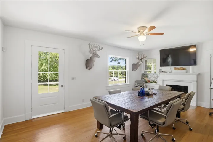This versatile room features warm wood flooring and abundant natural light.