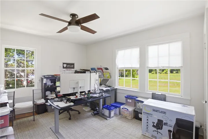 This bright office space offers ample natural light and a pleasant view, perfect for productivity.