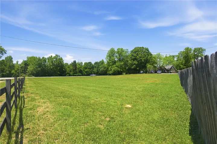 Expansive green space with mature trees, ideal for building your dream home.