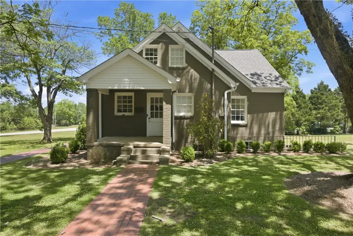 This charming home offers a welcoming facade with traditional architectural details and mature landscaping.