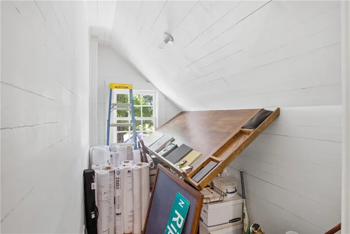 This bright attic space offers potential for creative pursuits or organized storage solutions.